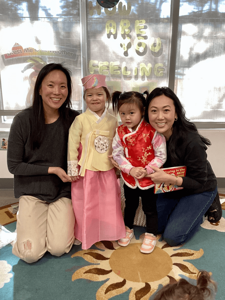 Parents and daughters who are wearing traditional cultural outfits