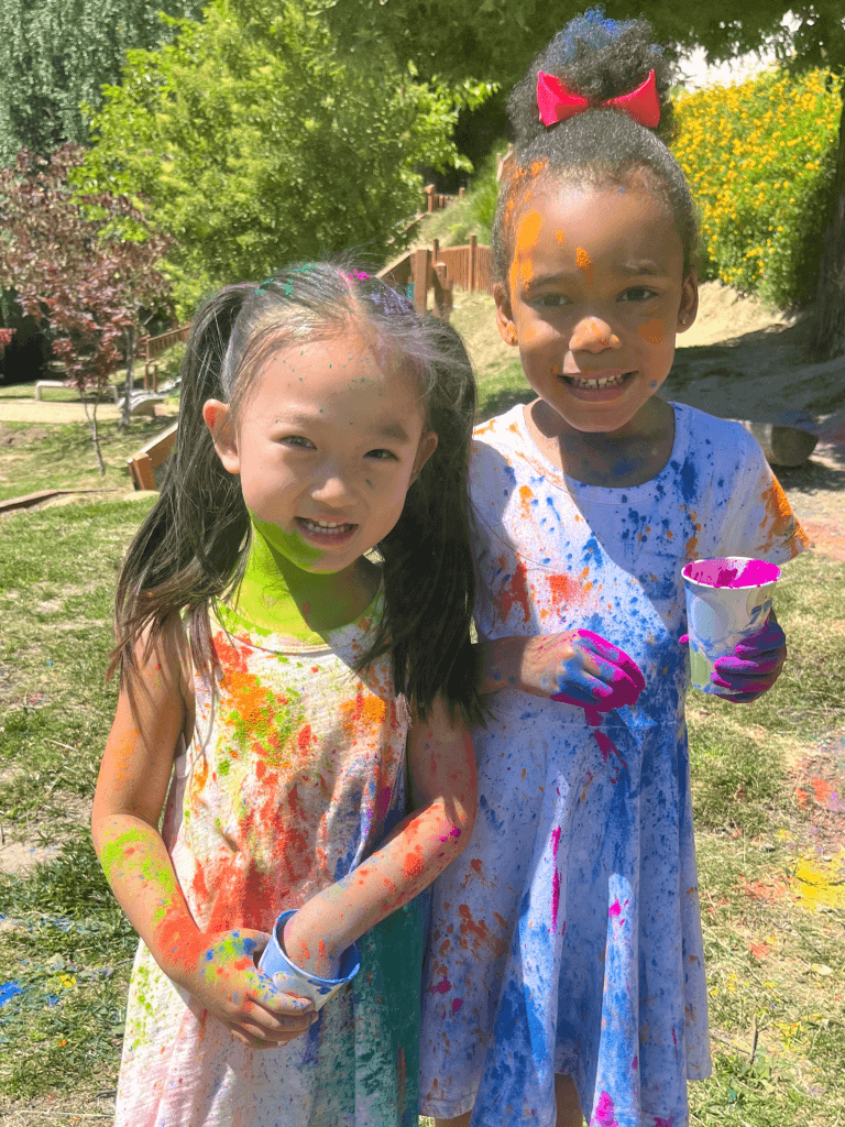 Two preschoolers covered in paint